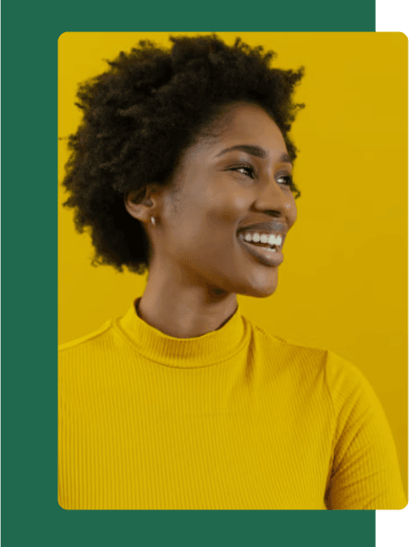 Confident and vibrant, a smiling woman in a yellow turtleneck embodies creativity and bold marketing strategies.